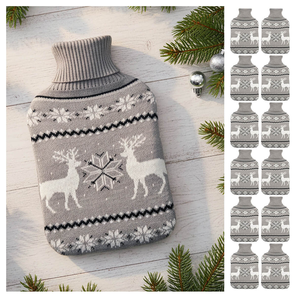 Christmas hot water bottle with grey and white reindeer and snowflake pattern on a wooden table with pine branches