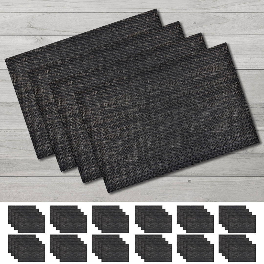 Set of black placemats on a wooden surface