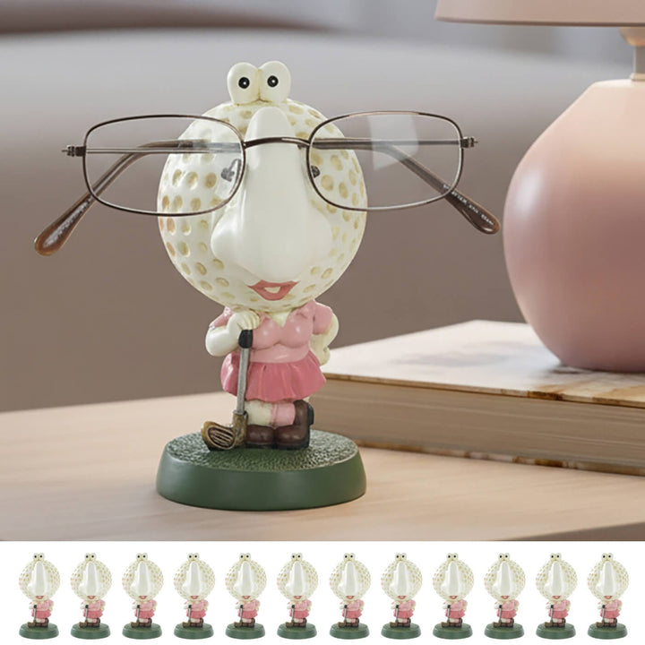 Lady golfer spectacles holder on a table with book and lamp