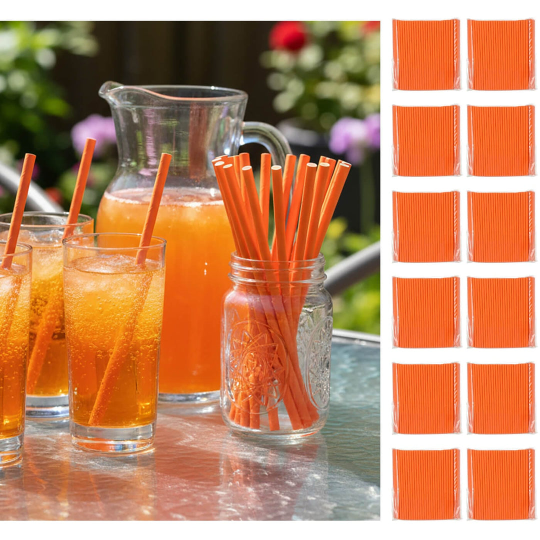Orange juice glasses with straws, a pitcher, and a jar of additional straws on a table outdoors.