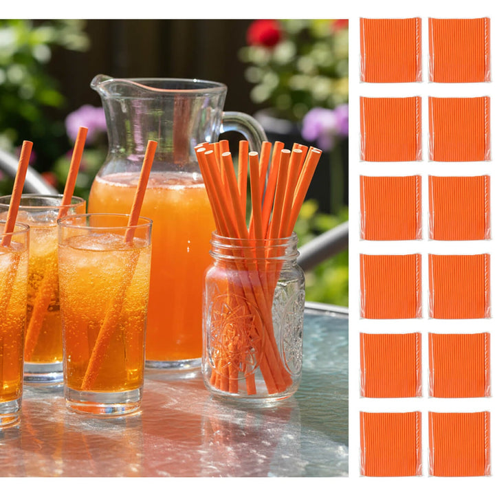 Orange juice glasses with straws, a pitcher, and a jar of additional straws on a table outdoors.