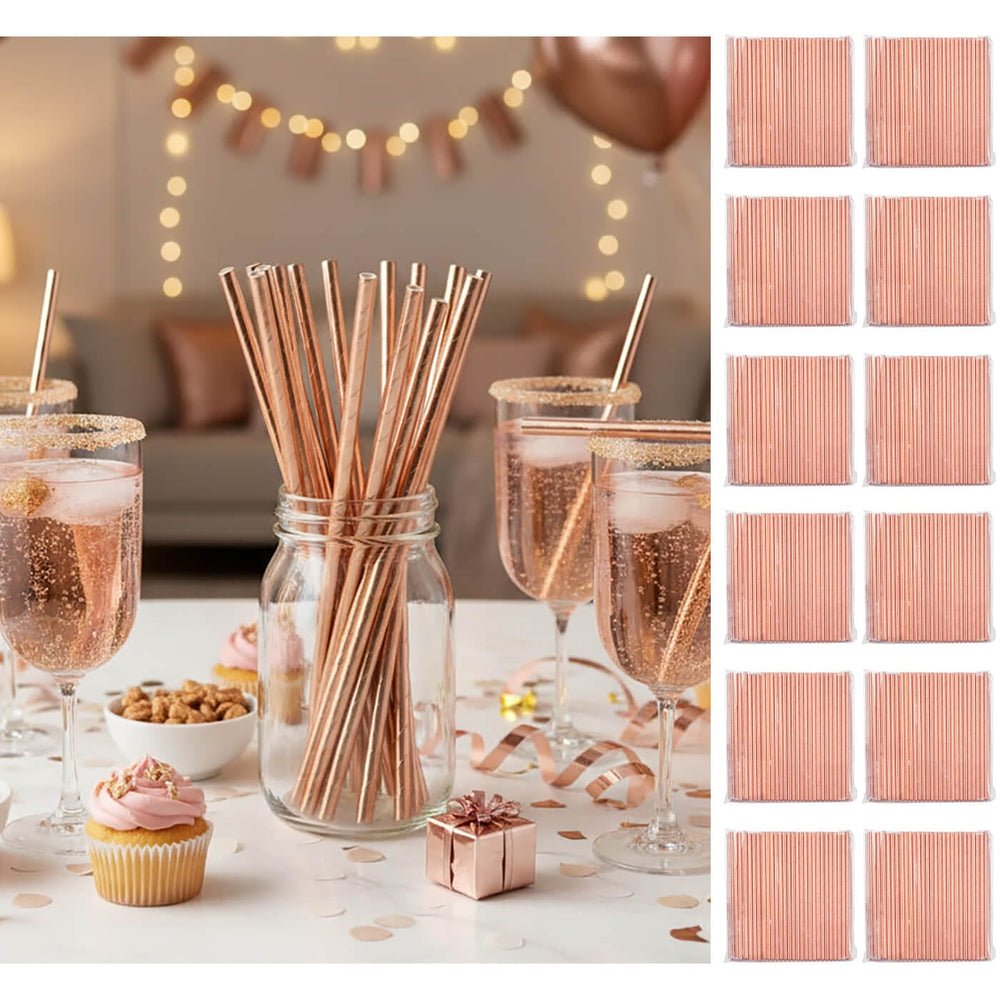 Rose gold straws in a jar with glasses of champagne, cupcake, and small gift on a festive table.