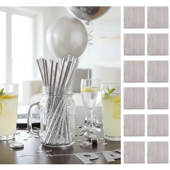 Silver paper straws in a jar with glasses of lemonade on a table, surrounded by silver party decorations.