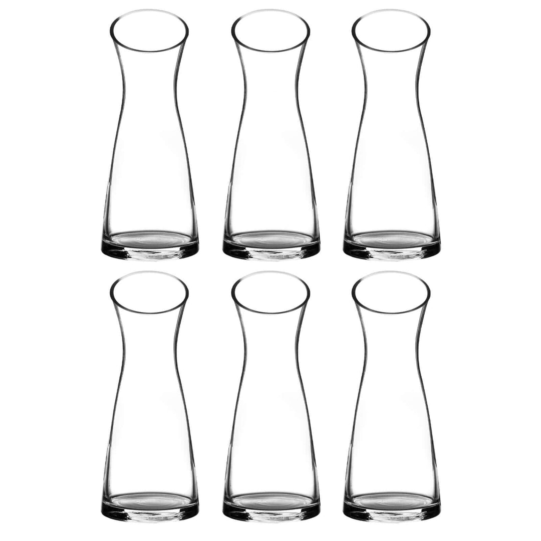 Set of six clear glass large flower vases on a white background