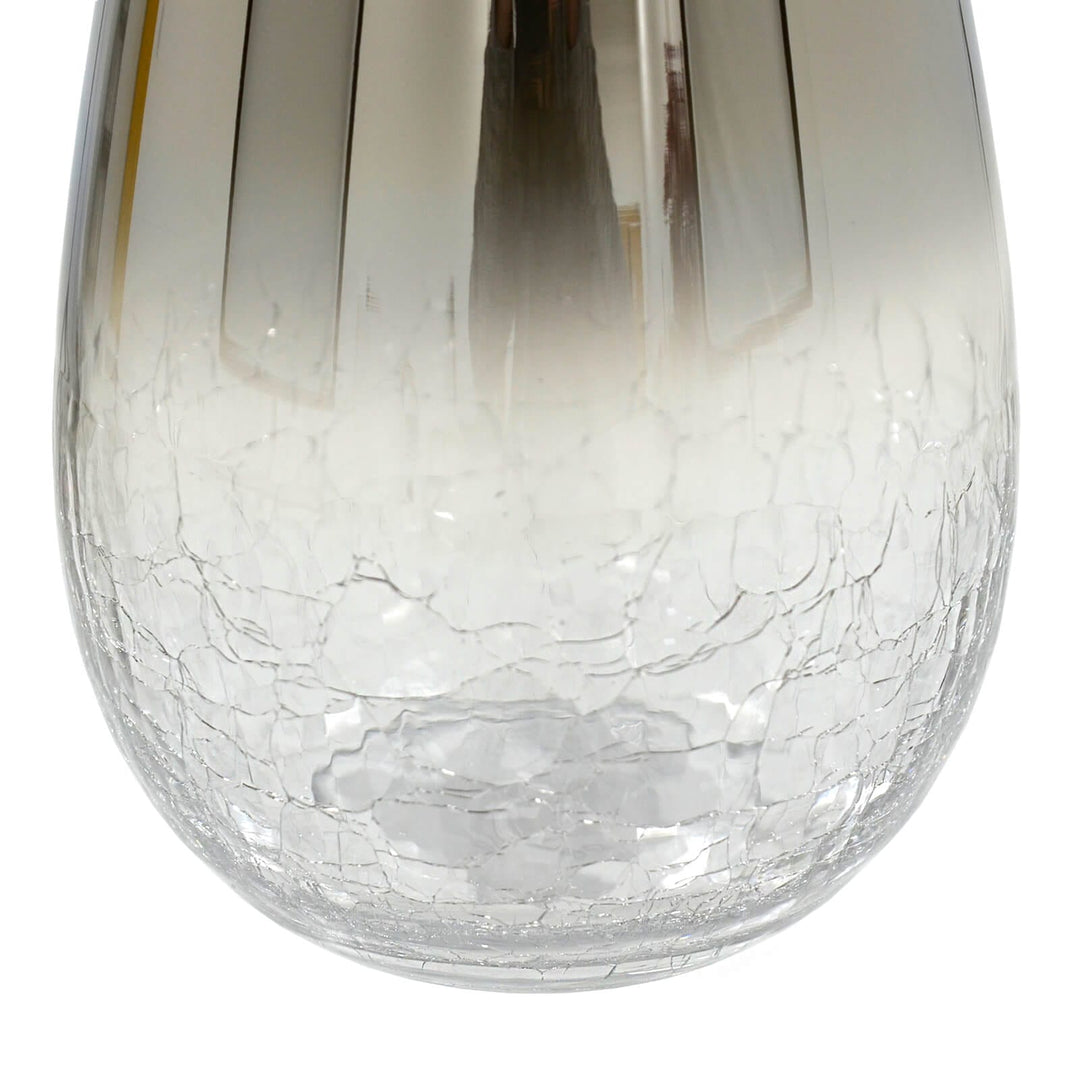 Close up of crackle glass base of a flower vase on a white background