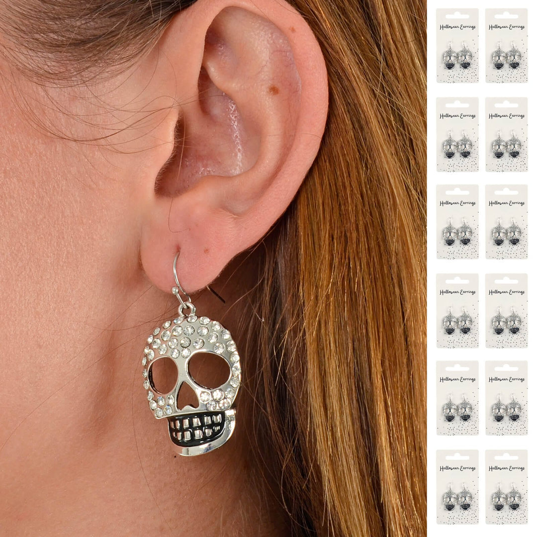 Skull-shaped earring worn by a person with a close-up of the ear.