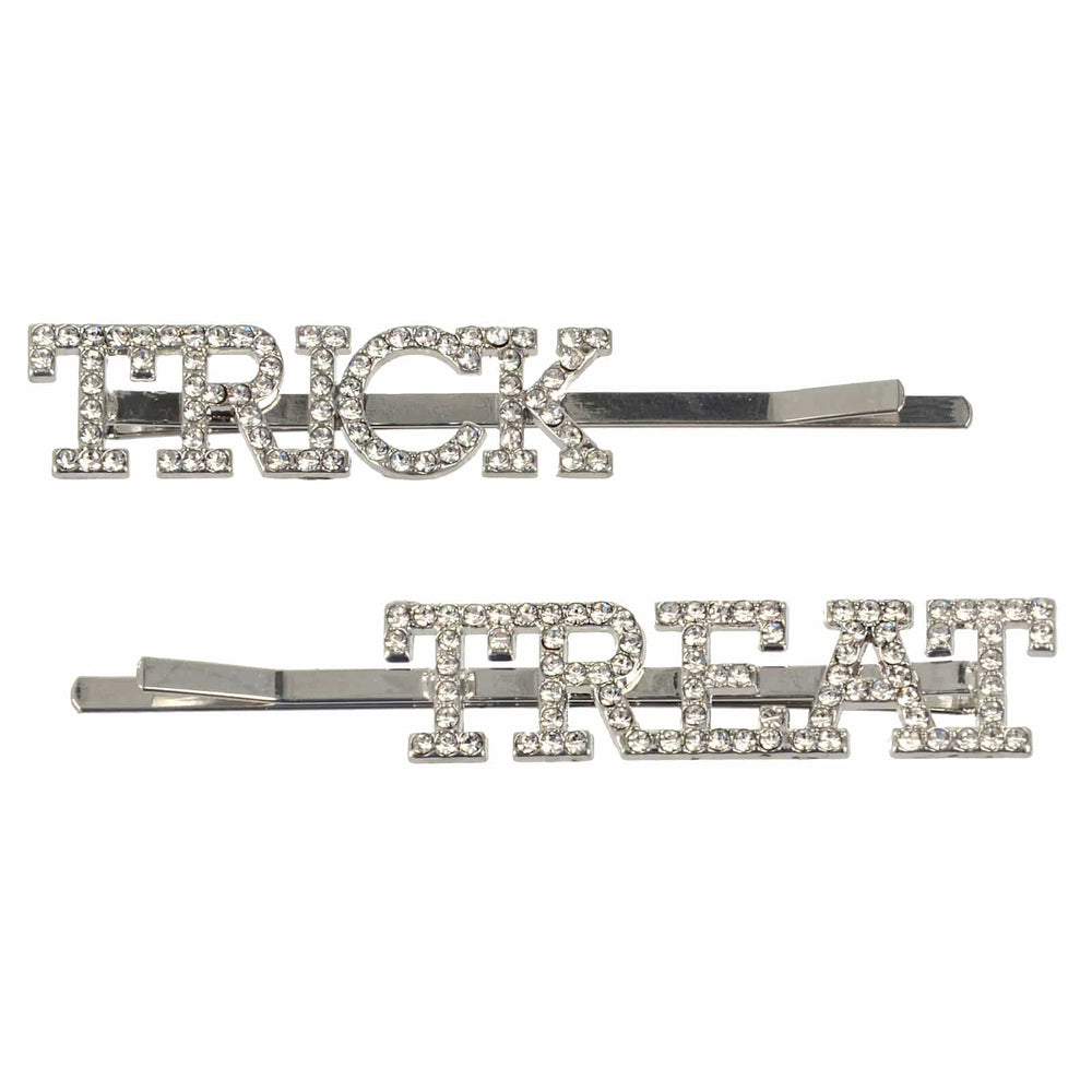 Two hair pins with 'TRICK' and 'TREAT' text on a white background