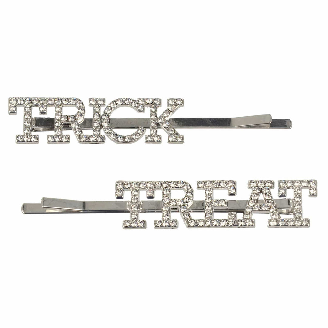 Two hair pins with 'TRICK' and 'TREAT' text on a white background