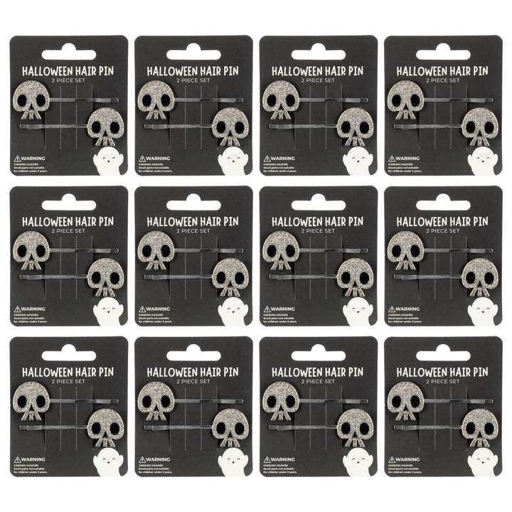 12 display cards with halloween skull hair pins on a white background