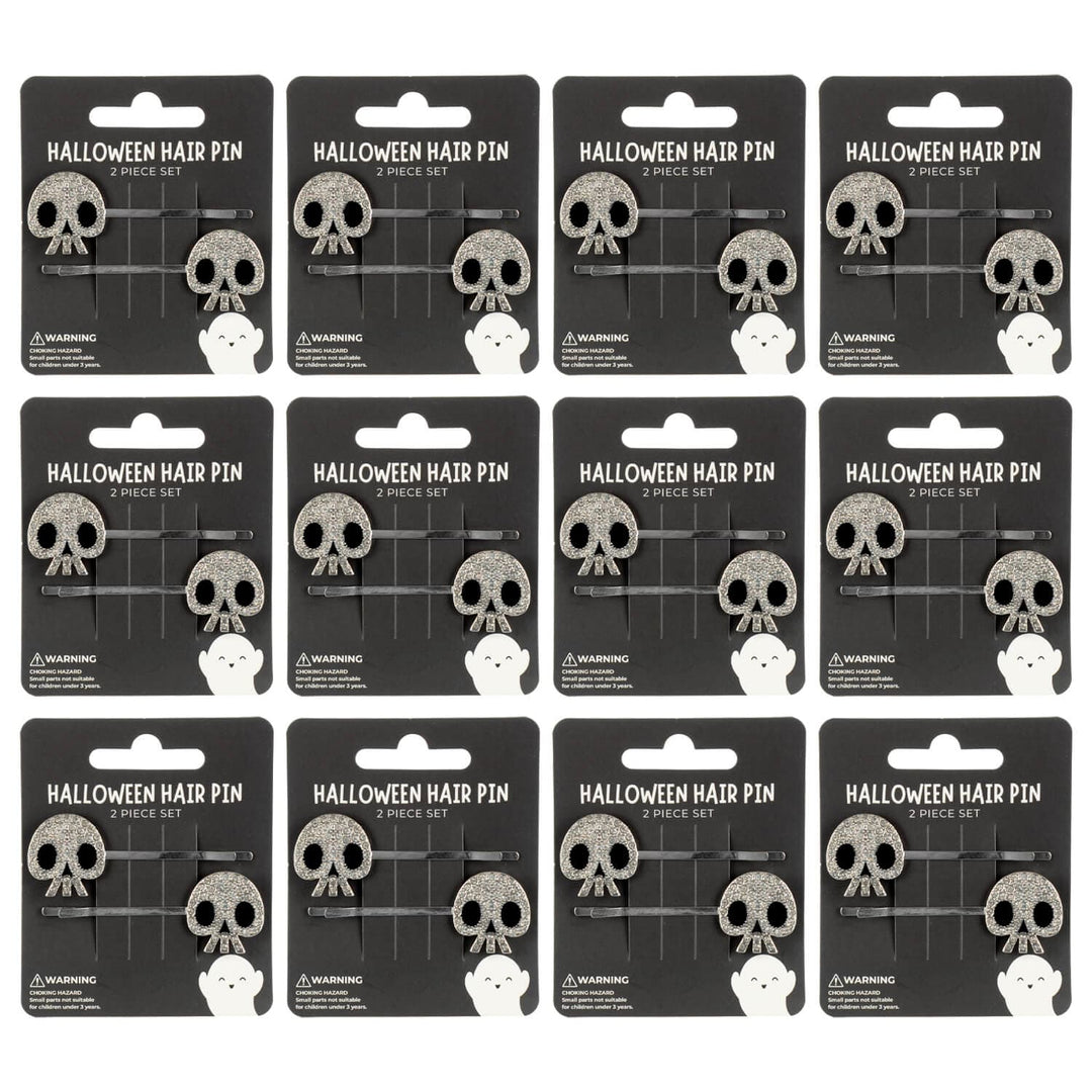 12 display cards with halloween skull hair pins on a white background