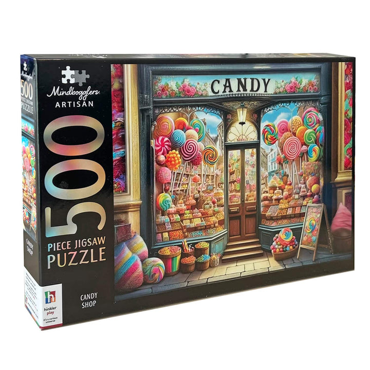 A 500-piece jigsaw puzzle box by Mindboggles Artisan, featuring a colorful illustration of a candy shop storefront with lollipops, sweets, and the words &
