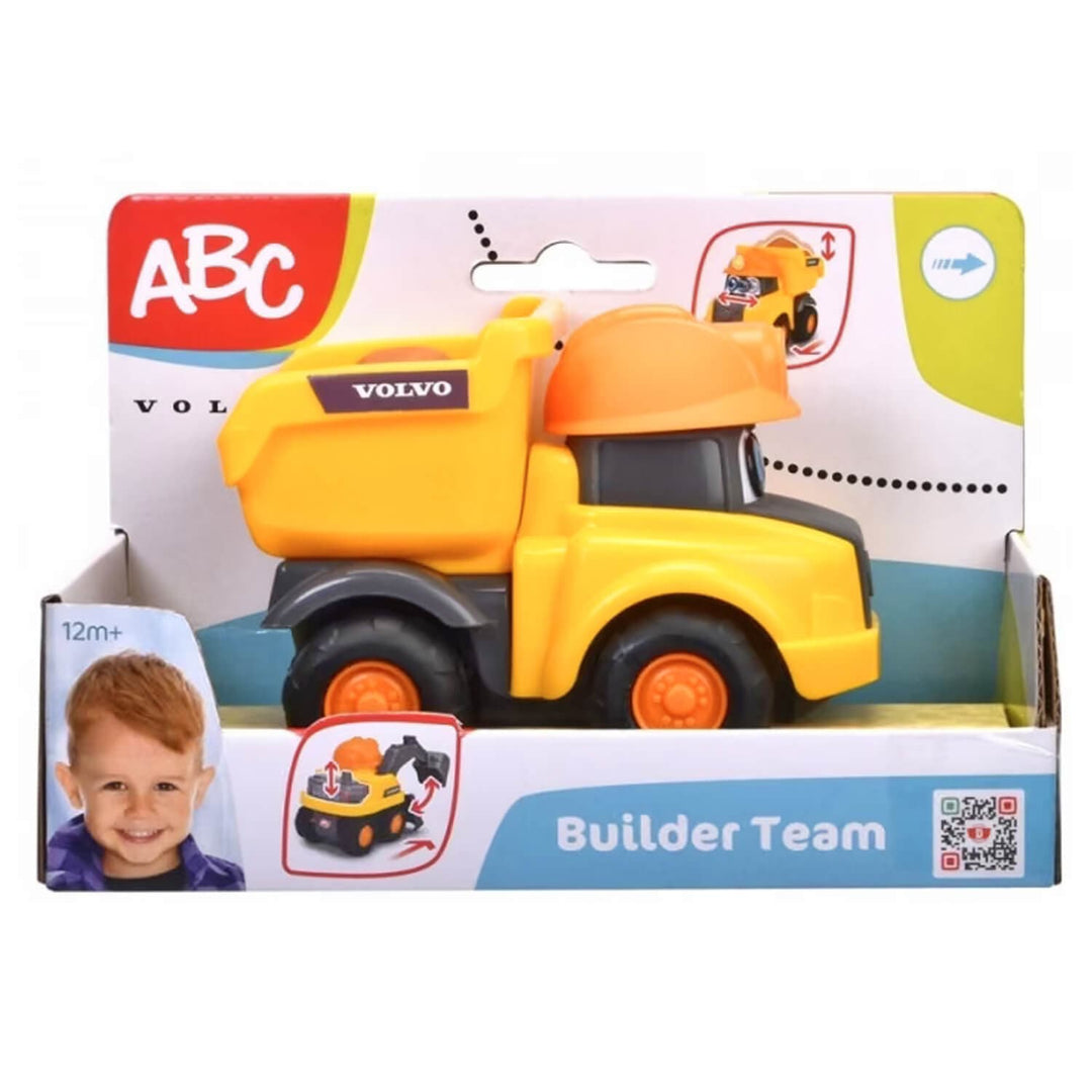 A yellow and orange toy dump truck in its original retail packaging, featuring the Volvo logo on the truck and an 'ABC Builder Team' design on the box.