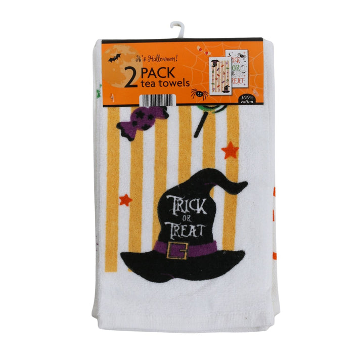 A 2-pack of Halloween-themed tea towels in retail packaging. The towels are white with a printed design featuring yellow vertical stripes, a black witch hat with a purple band and &