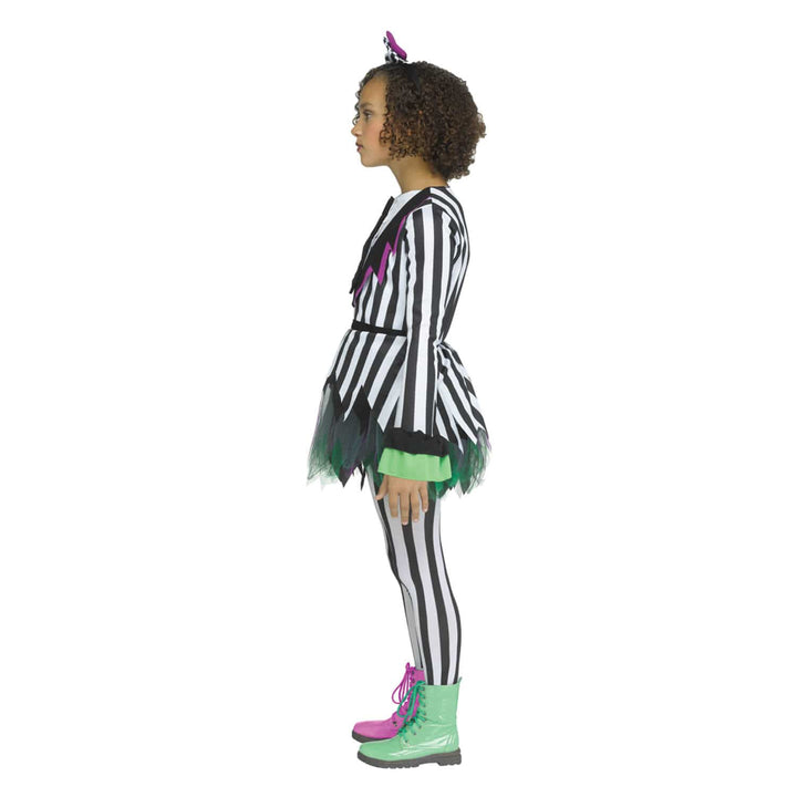 A child model shown in profile wearing a black and white striped costume with green and pink accents, black-and-white striped tights, green and pink lace-up boots, and hair bow, on a plain white background.