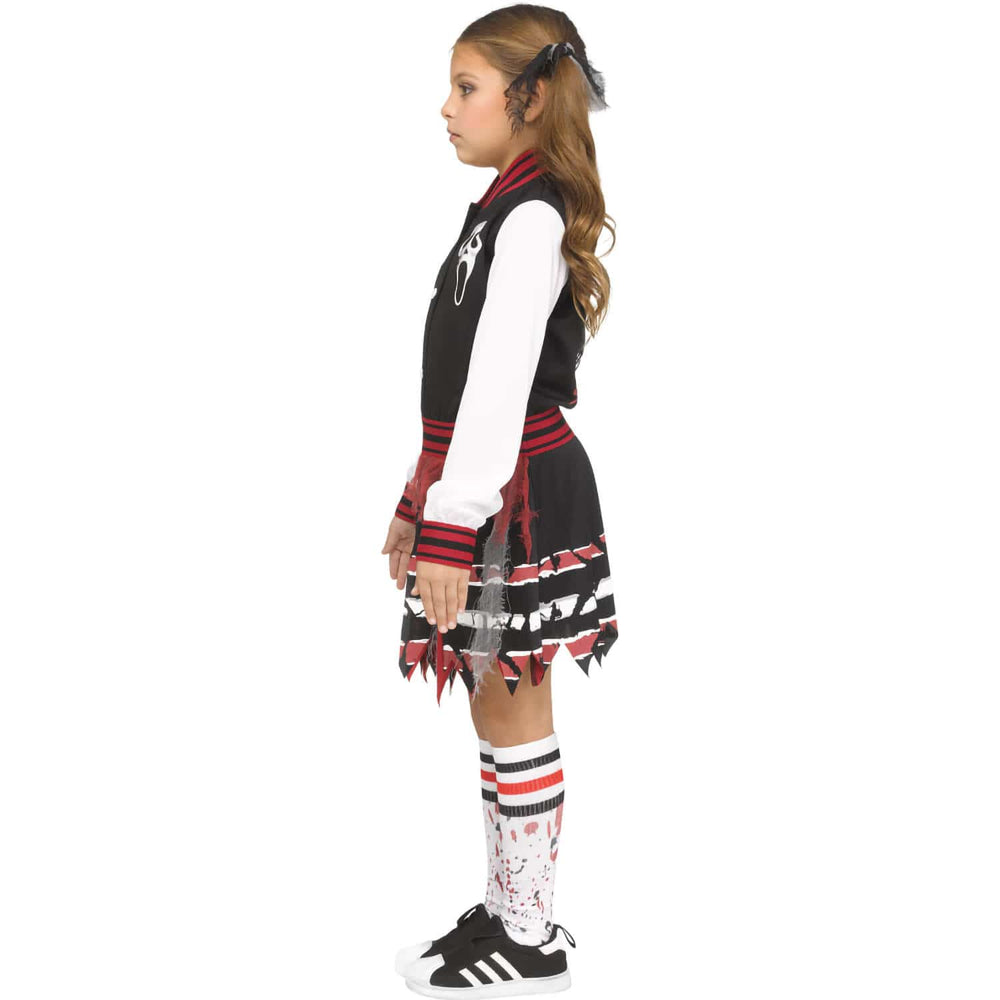 Child wearing a black and red Scream cheerleader fancy dress outfit with a skirt on a white background