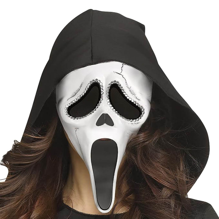 A person wearing a Ghost Face mask with rhinestone detail around the eyes and a black hood
