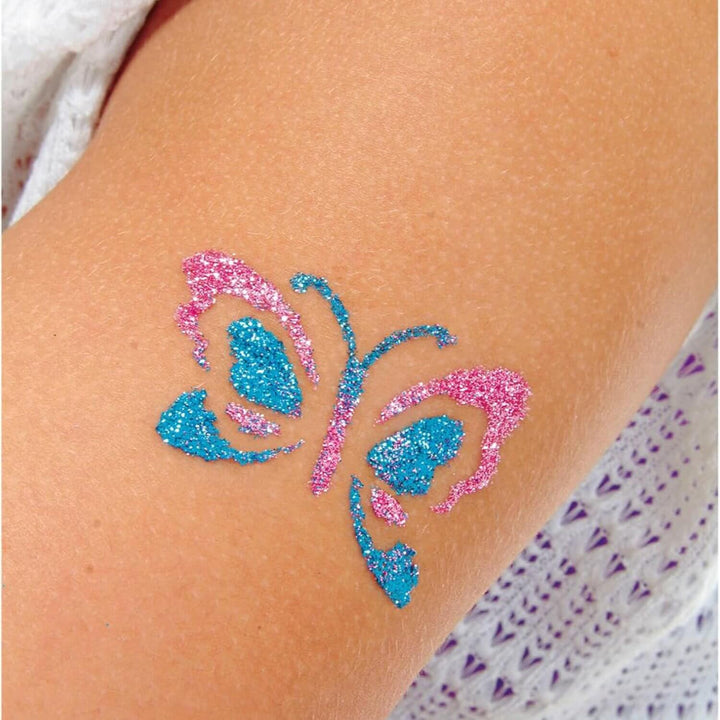 Blue and pink glitter butterfly tattoo on a person&