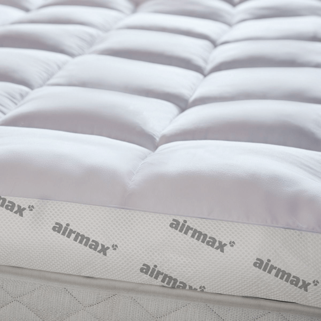 Close-up of a mattress with 'airmax' branding on a white background