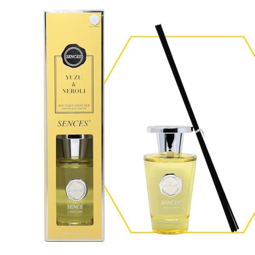 Sences Yuzu &amp; Neroli reed diffuser with a yellow box, a clear glass bottle filled with pale yellow liquid, a silver cap, and a black reed stick on a white background.