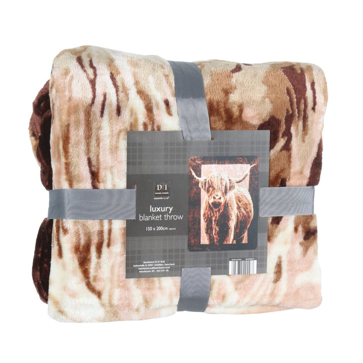 blanket throw folded and wrapped in grey ribbon with brand tab