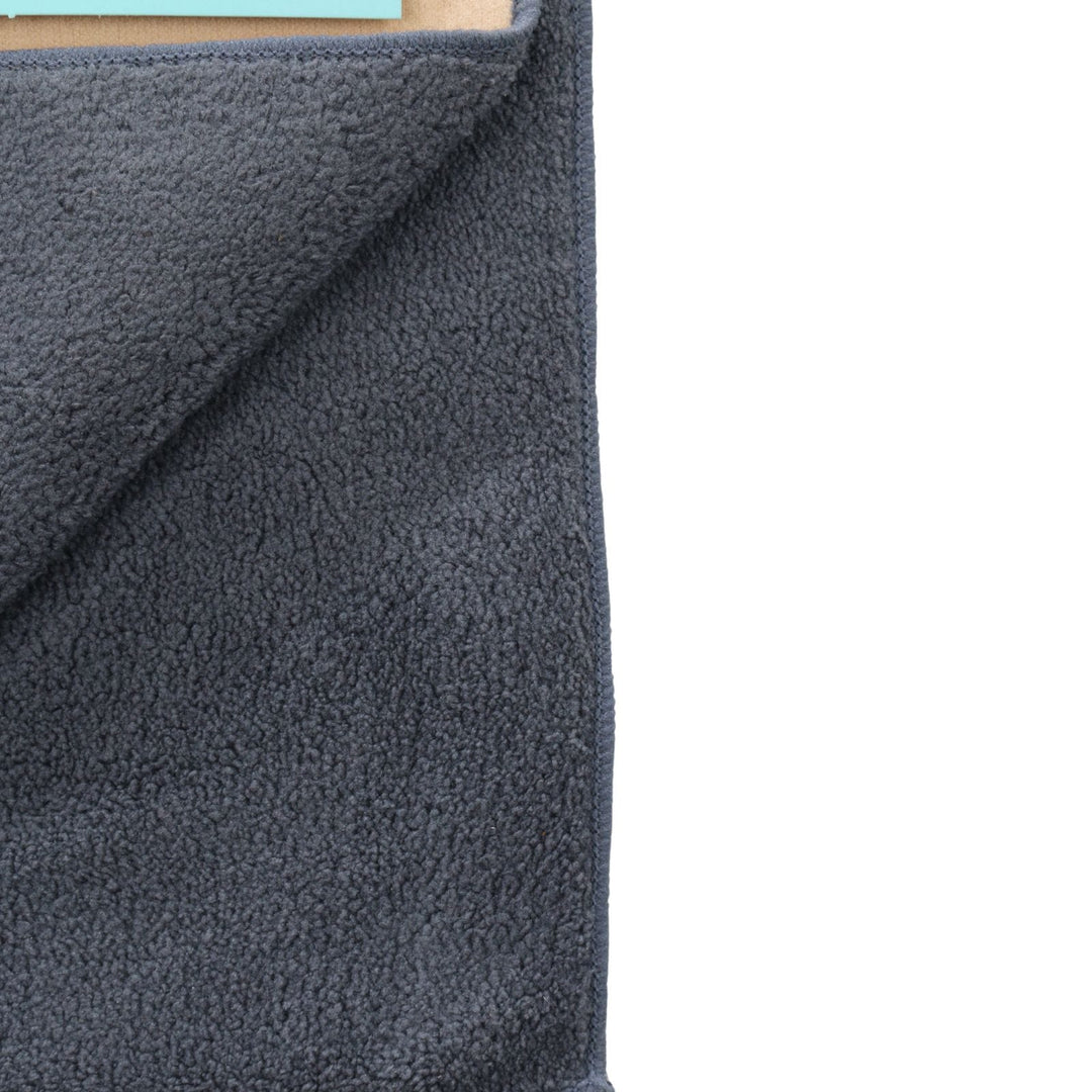 Close-up of gray textured fabric on microfibre car towel on a white background