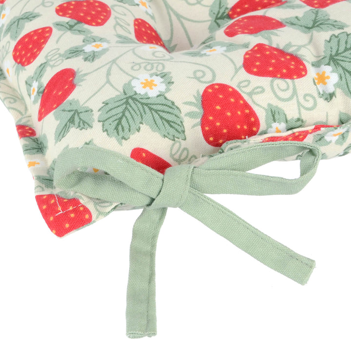 Sage green tie on a strawberry pattern seat cushion