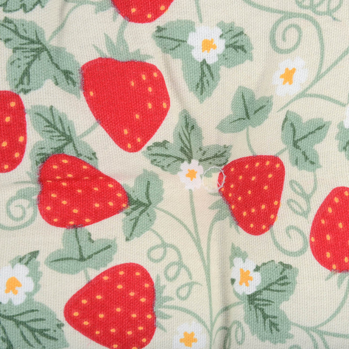 Close up detail of an upholstered seat cushion with strawberries pattern