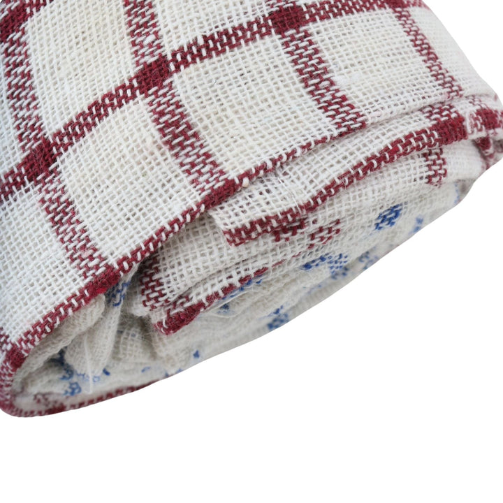 Red and white checkered tea towel fabric with a patterned border on a white background