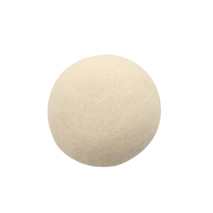 close up of single white tumble dryer ball on white background