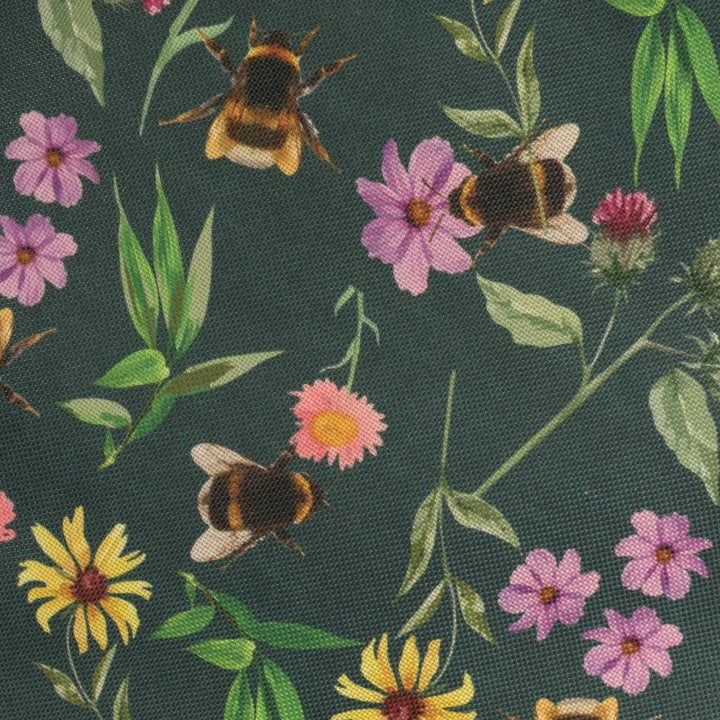 Fabric on garden caddy with bees and flowers pattern on a dark green background