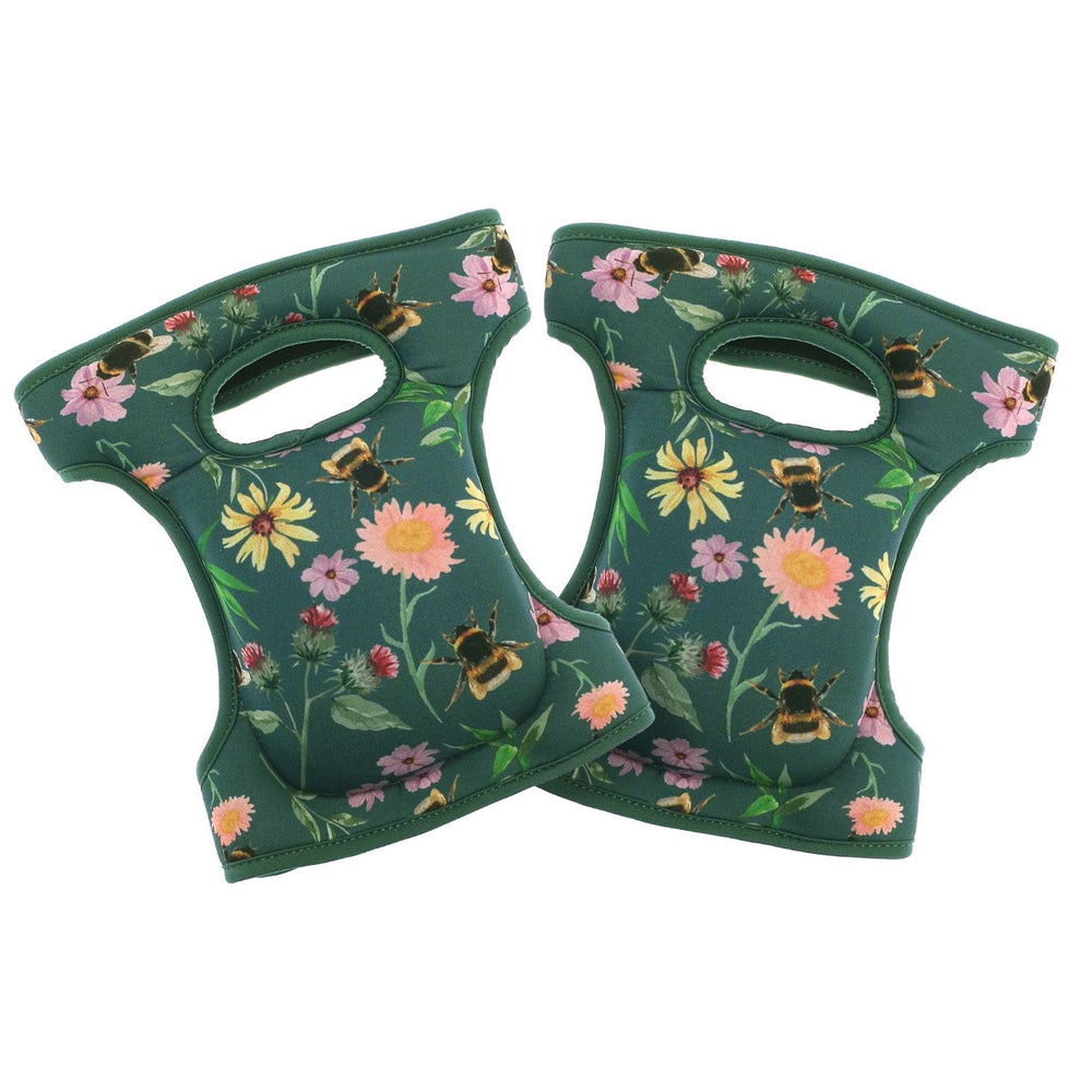 two green fabric knee pads with cushioning and green floral & bee pattern on white background