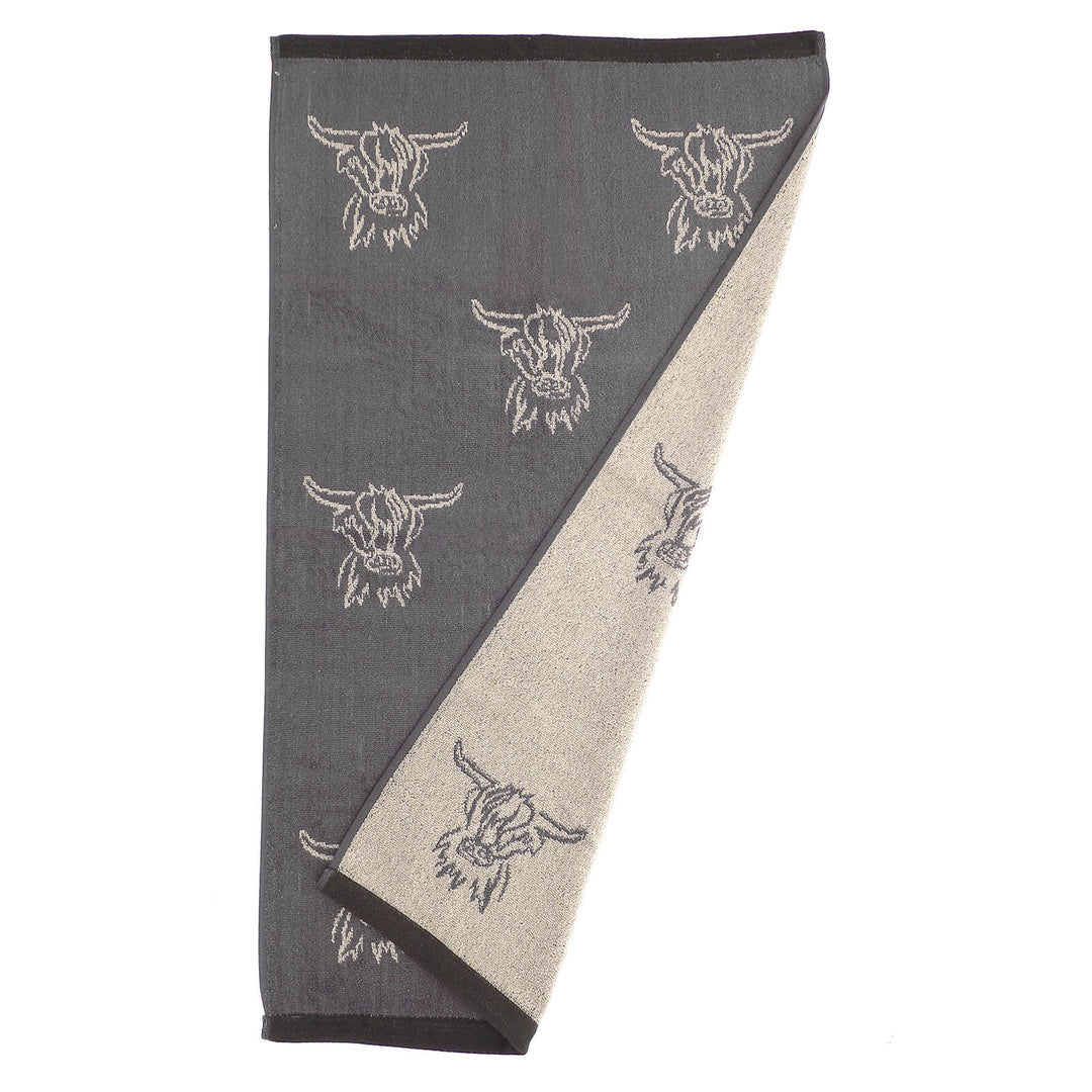 Hand towel with reversible grey and white highland cow head pattern