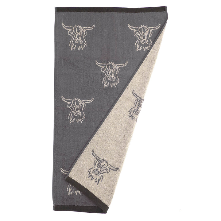 Hand towel with reversible grey and white highland cow head pattern