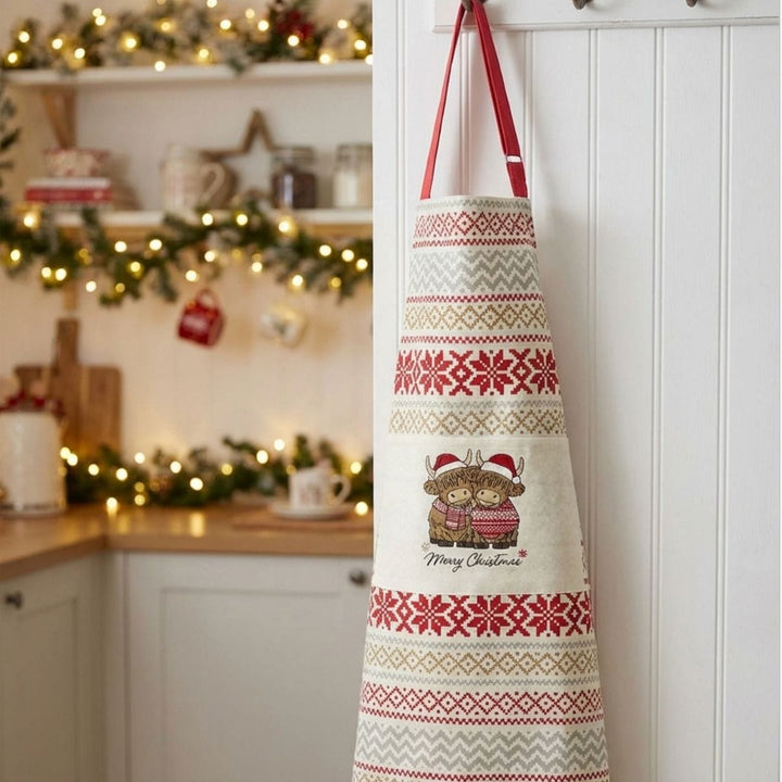 Decorative apron with Christmas pattern hanging in a kitchen.