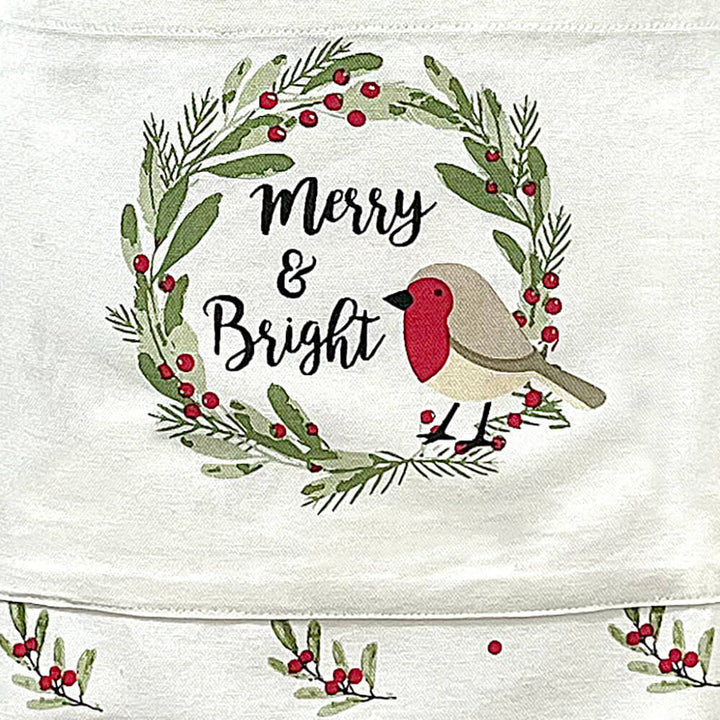 Close up of Christmas robin with Merry & Bright text on a festive apron pocket