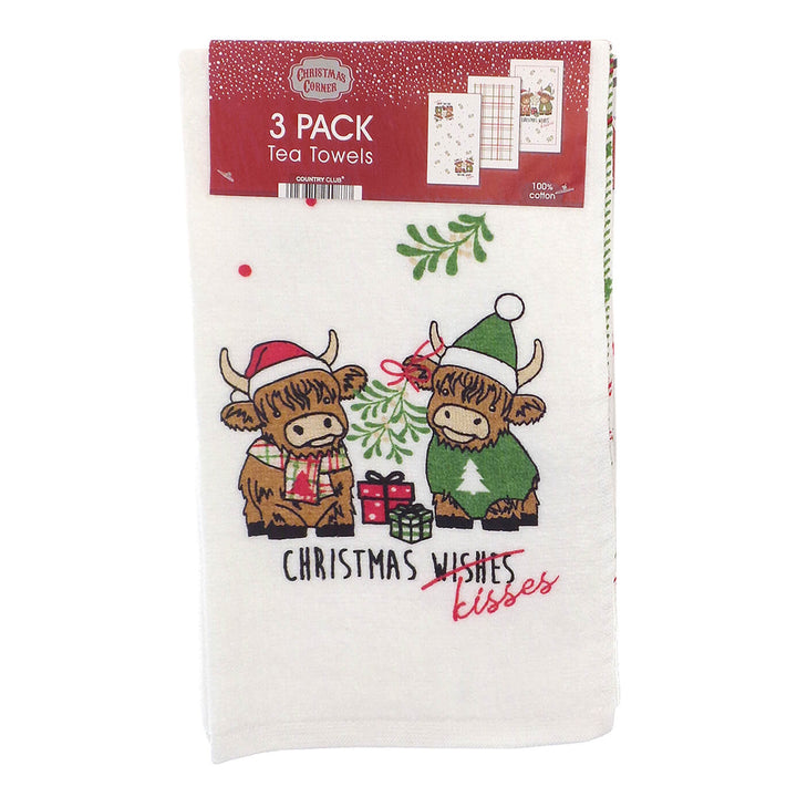 Pack of 3 Christmas Kisses tea towels featuring Highland cows under the mistletoe