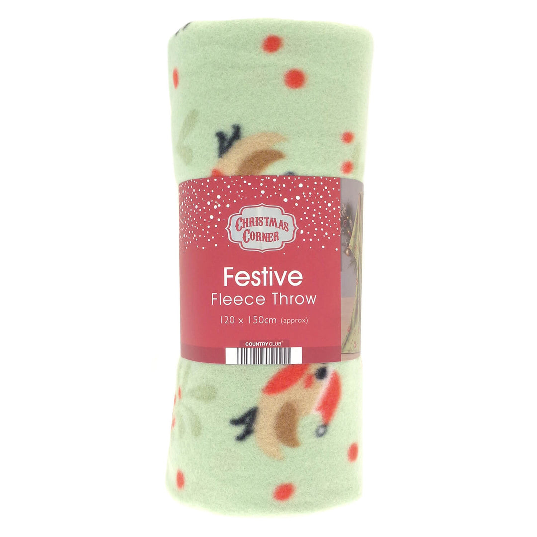 A rolled Christmas-themed fleece throw blanket in pale green with red polka dots and festive robins, wrapped in a red paper label that reads 'Christmas Corner' and 'Festive Fleece Throw'.