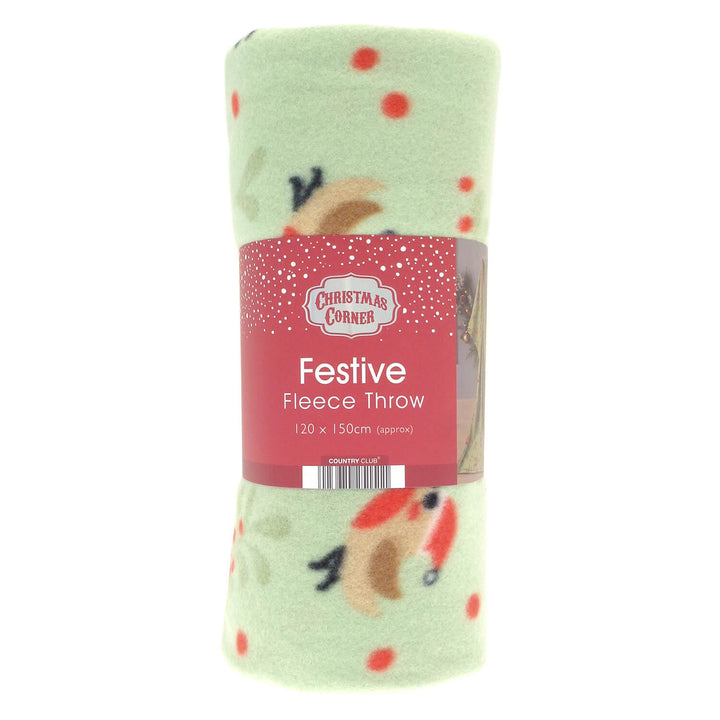 A rolled Christmas-themed fleece throw blanket in pale green with red polka dots and festive robins, wrapped in a red paper label that reads 'Christmas Corner' and 'Festive Fleece Throw'.