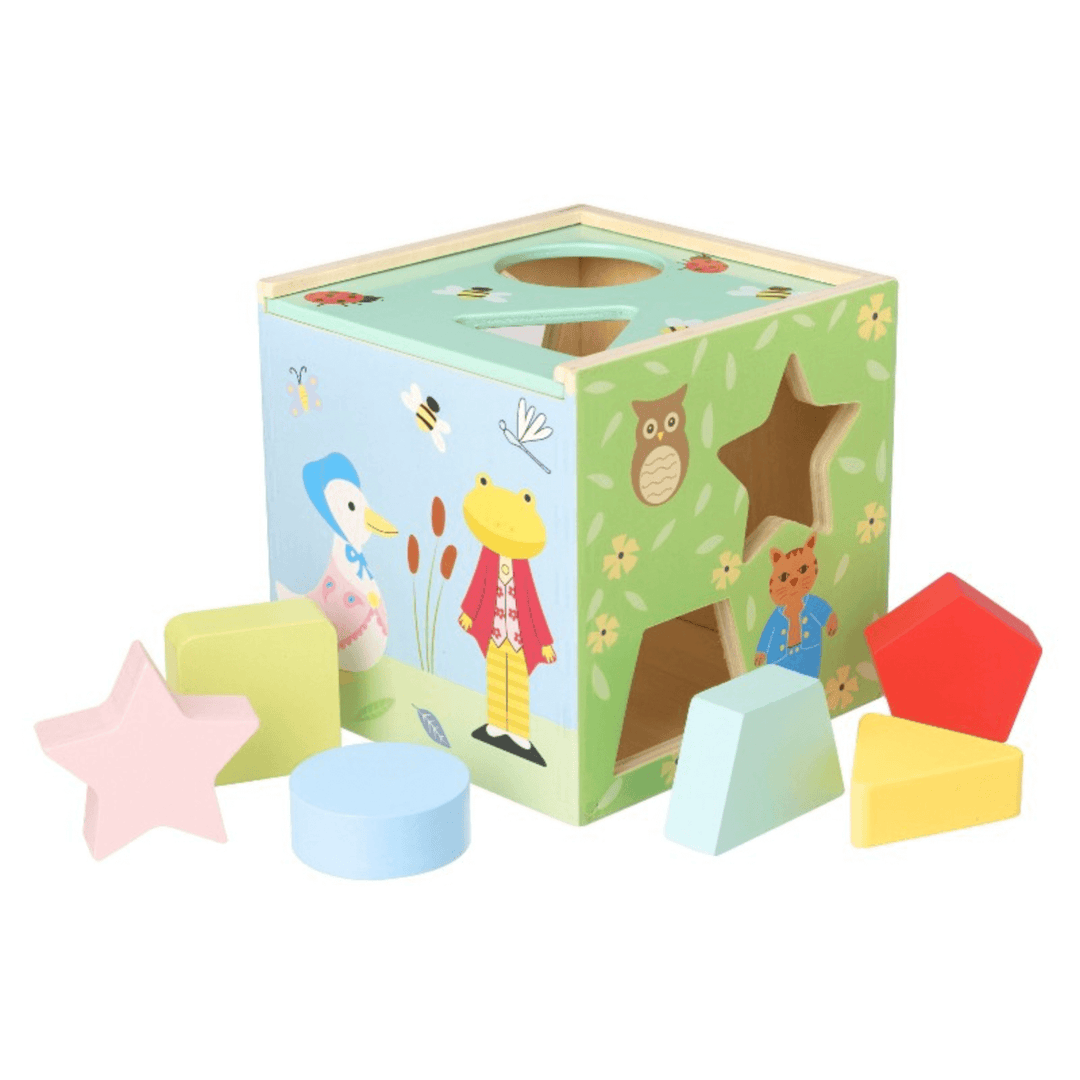 wooden shape sorter toy with star, rounded rectangle, triangle and more chunk shapes to insert into sorter with peter rabbit characters and illustrations 