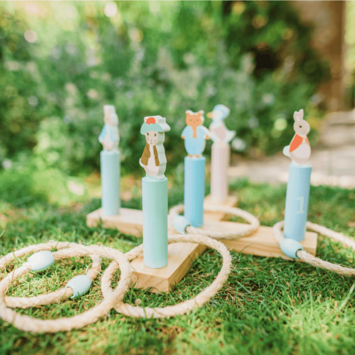 hoopla game on grass in garden with trees in background