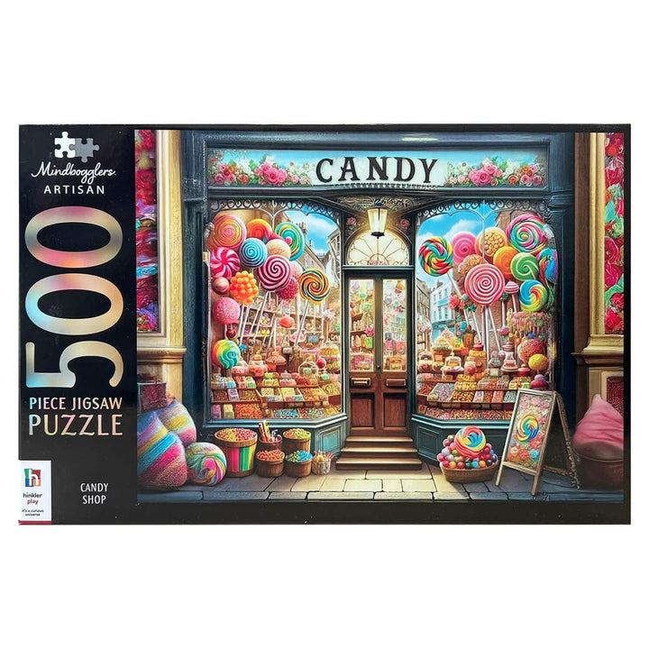 Front of a 500-piece jigsaw puzzle box by Mondragone Artisan, featuring a colorful candy shop storefront with large lollipops, sweets, and the words &