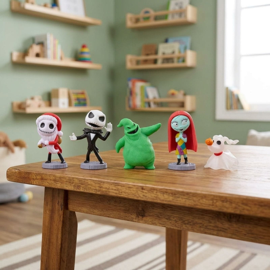 Five Disney The Nightmare Before Christmas character figurines arranged on a wooden table in a child's bedroom. The set includes Jack Skellington, Sally, Oogie-Boogie, Zero & Sandy Claws