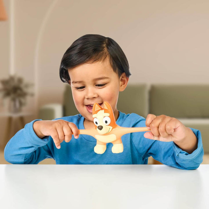 Child stretching the arms of a stretch Bingo action figure