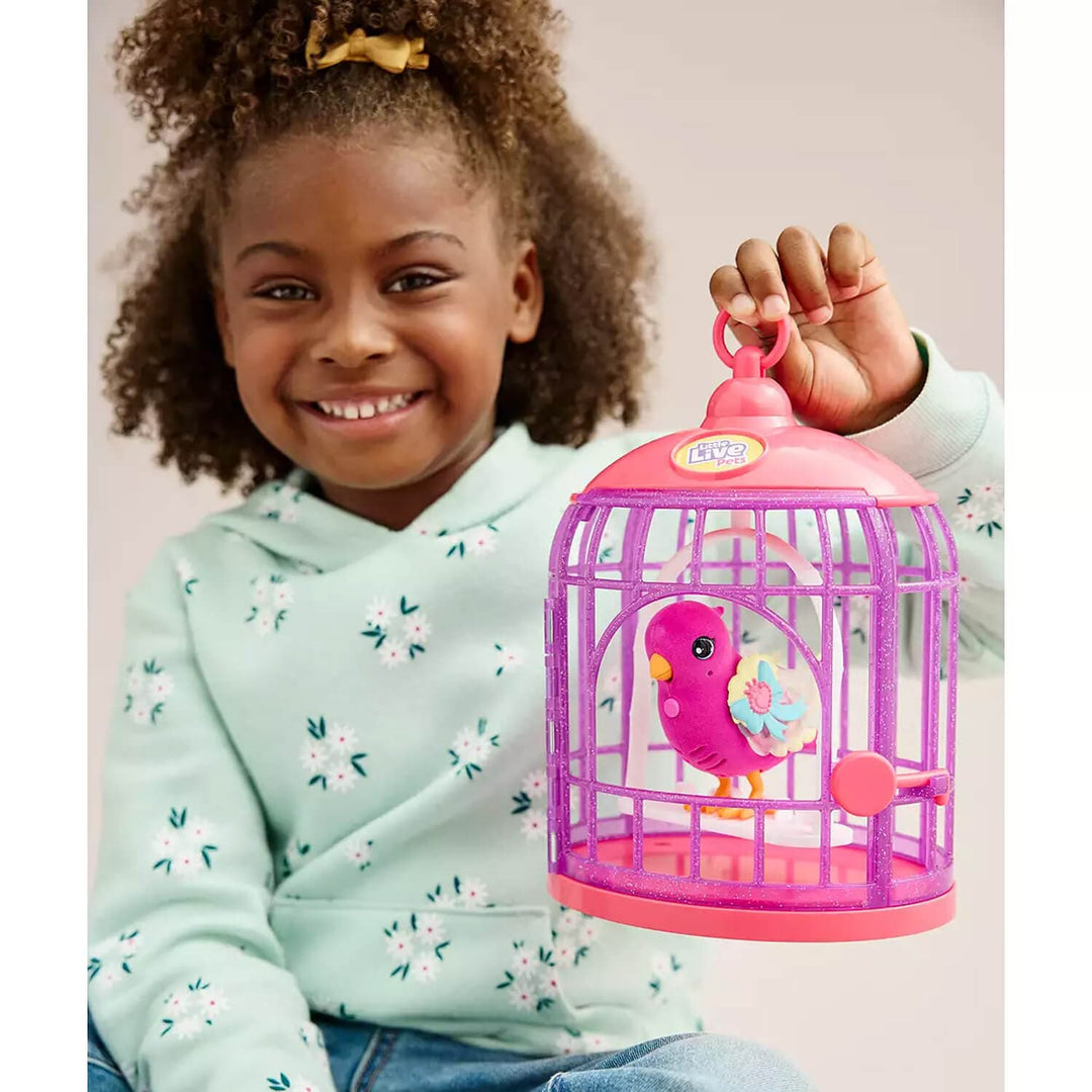 Child holding a toy birdcage with a bird inside, smiling.