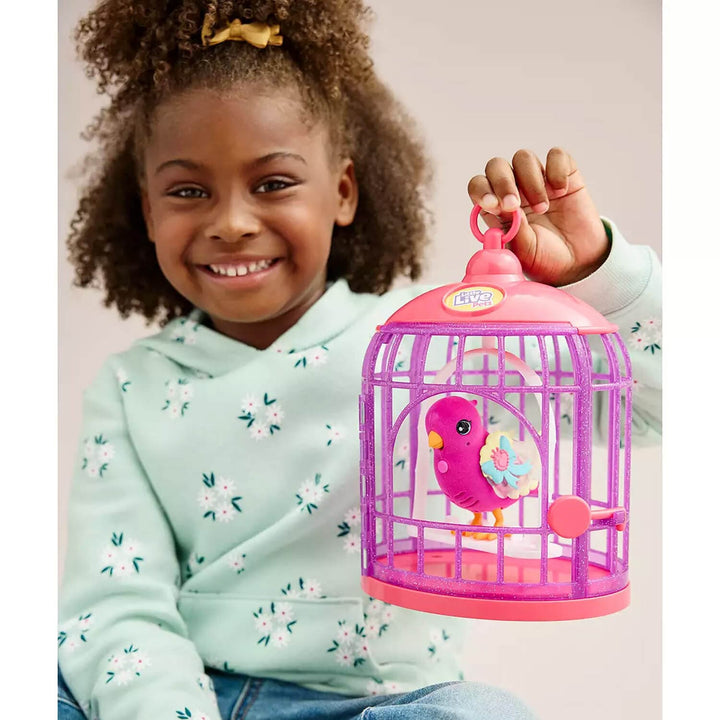 Child holding a toy birdcage with a bird inside, smiling.