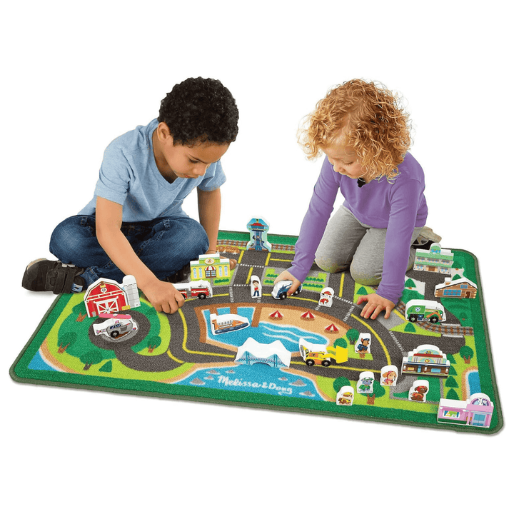 young boy and girl play on top of activity rug with wooden vehicle block and paw patrol character blocks