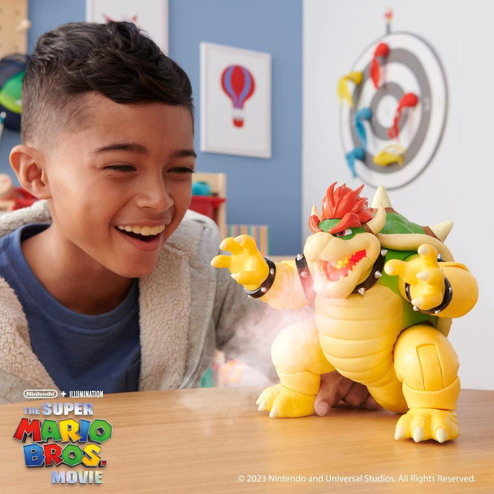 Child playing with a Bowser toy from The Super Mario Bros. Movie in a play room with colourful decorations.