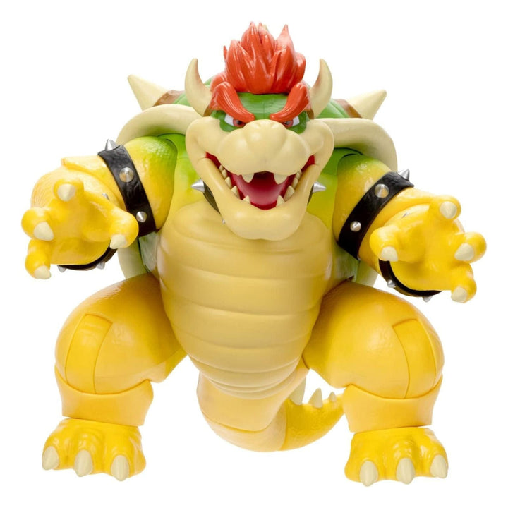 Toy figure of a yellow creature with red hair on a white background - Bowser from Super Mario