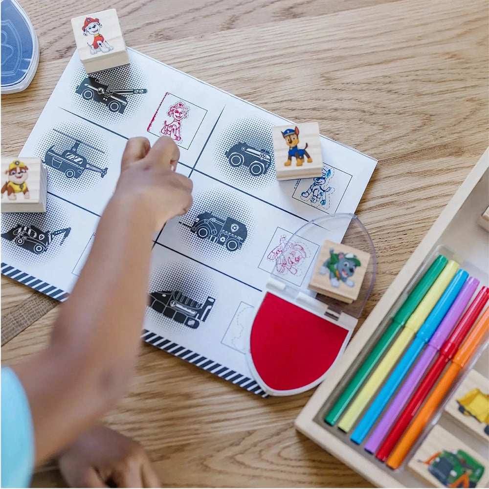 Child using a Paw patrol stamp set with activity pad