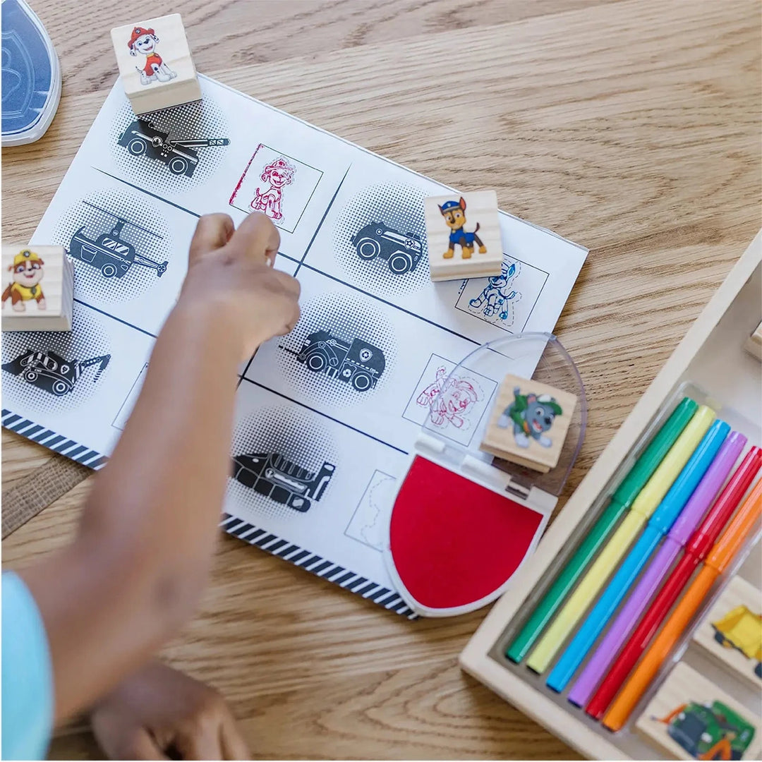 Child using a Paw patrol stamp set with activity pad
